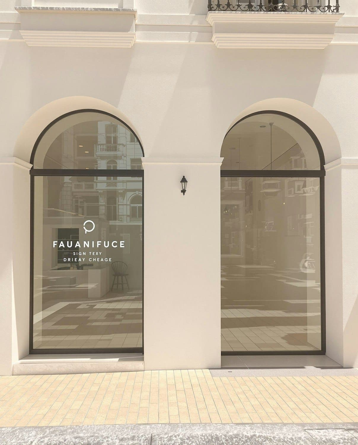 The new entrance in the former shopfront bay, arched glazing set into cream stone